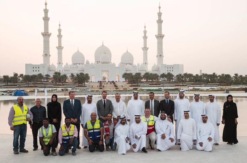 Sheikh Mohammed stands for a photograph with staff involved in the design and construction of Wahat Al Karama. Seen with Sheikh Khalifa bin Tahnoon (bottom row 6th R), and Mohammed Al Mubarak (bottom row 5th R). Ryan Carter / Crown Prince Court — Abu Dhabi