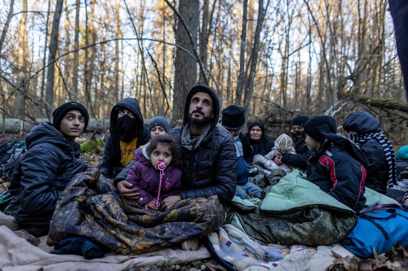 A Kurdish family from Dohuk, Iraq, in a forest near the Polish-Belarus border, as they wait to try to cross into the EU. AFP