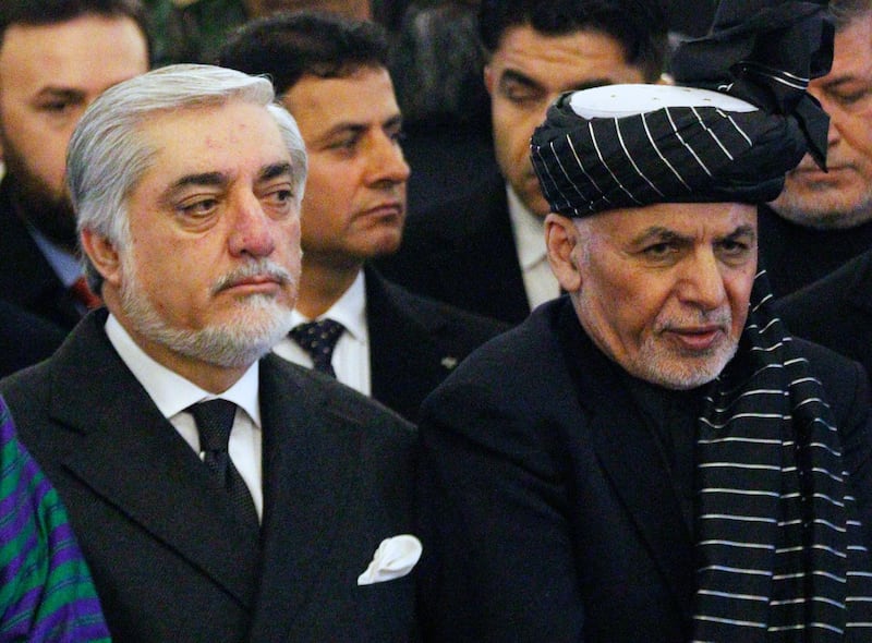 epa08427405 (FILE) - Afghanistan's president Mohammad Ashraf Ghani (R) and Afghanistan's chief executive Abdullah Abdullah (L) attend the funeral prayers ceremony of Subghatullah Mujadidi, former president of Afghanistan in the presidential palace in Kabul, Afghanistan, 13 February 2019 (reissued 17 May 2020). The months-long dispute over who won last year’s presidential election is near resolution after the incumbent Ashraf Ghani and his main challenger Abdullah Abdullah agreed a draft power-sharing deal, according to media reports 17 May 2020.  EPA/JAWAD JALALI *** Local Caption *** 56004567