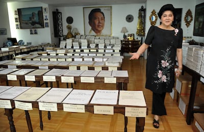 Former Philippines first lady Imelda Marcos walking past her voluminous pending court cases during an interview with AFP at her residence in Manila in 2009. AFP