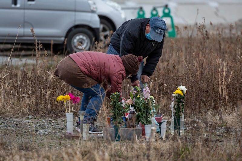 People visit a memorial for the victims of the 2011 Tohoku earthquake and tsunami in Namie, Japan. Ceremonies to mark the 10th anniversary of the disaster are expected to be scaled back because of the Covid-19 pandemic. Getty
