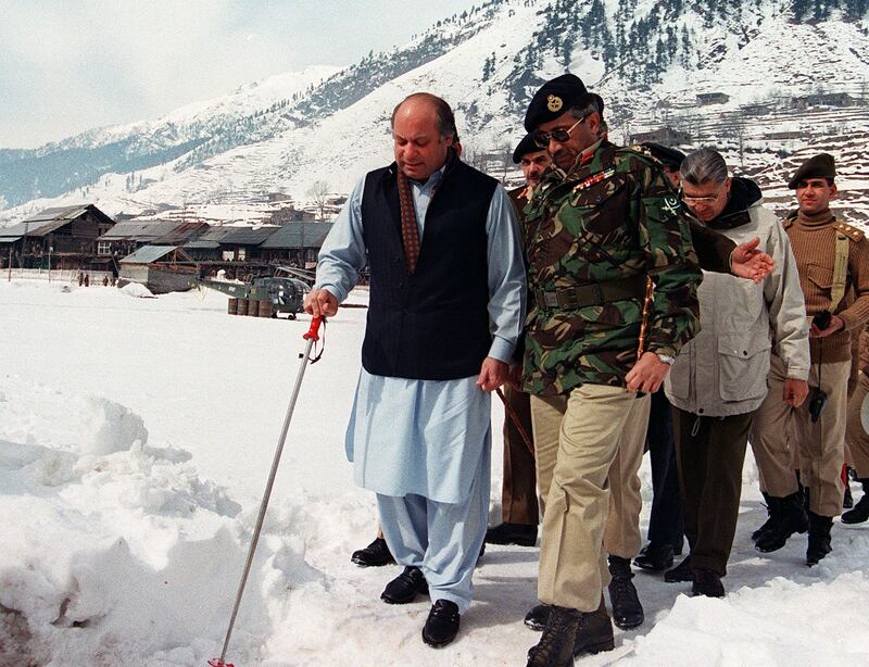 Pakistani Prime Minister Nawaz Sharif, left, flanked by army chief General Pervez Musharraf, on his way to address the army at Keil, close to the Line of Control, which divides Pakistan and Indian parts of Kashmir. AFP