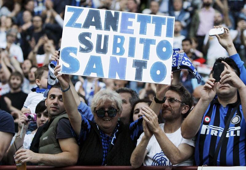 An Inter Milan fan holds up a sign. The sign reads, ”Zanetti, make him a saint now”. Zanetti’s finale was also marked by a solitary fan running onto the pitch in the 90th minute to salute the man who has come to be simply known as ‘Il Capitano’. Alessandro Garofalo / Reuters