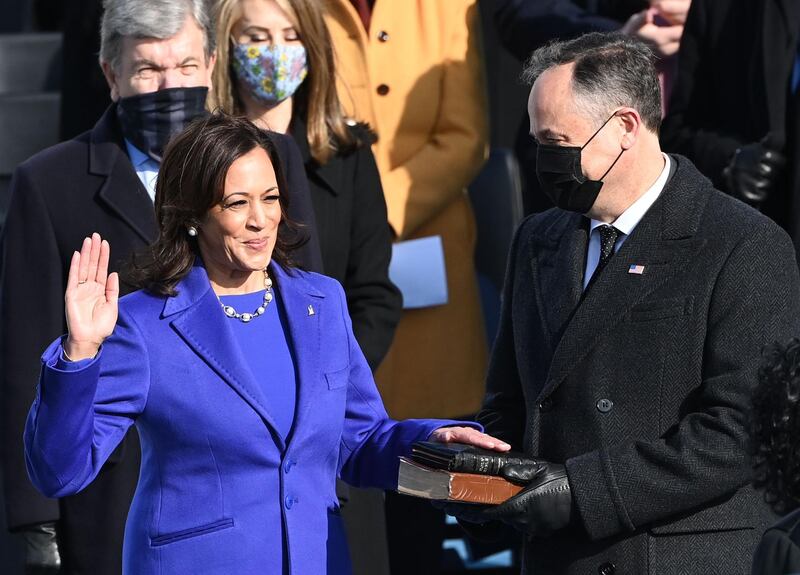 Kamala Harris, flanked by her husband Doug Emhoff, is sworn in as US Vice President by Supreme Court Justice Sonia Sotomayor on January 20. AFP