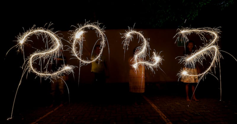 Sri Lankans writing '2023' with firecrackers during New Year's Eve celebrations in Colombo.  EPA 