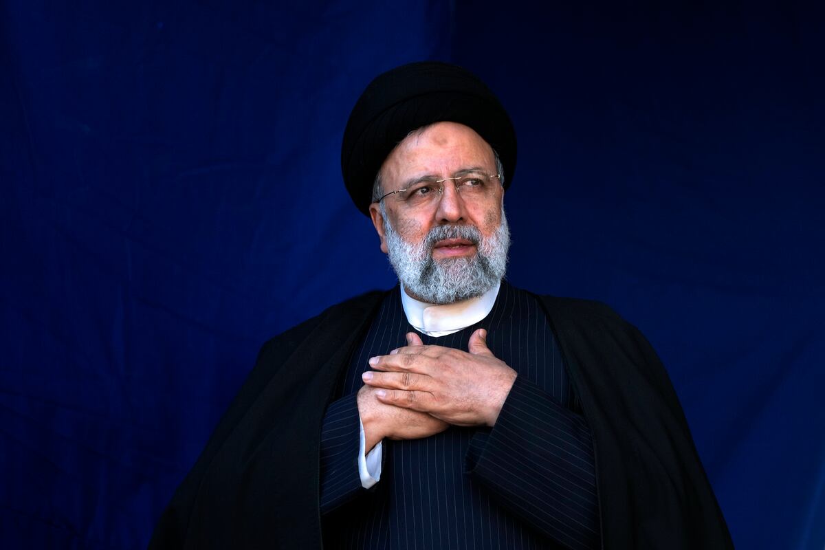 FILE- Iranian President Ebrahim Raisi places his hands on his heart as a gesture of respect to the crowd during the funeral ceremony of the victims of Wednesday's bomb explosion in the city of Kerman about 510 miles (820 kms) southeast of the capital Tehran, Iran, Jan.  5, 2024.  A helicopter carrying Iranian President Ebrahim Raisi suffered a “hard landing” on Sunday, May 19, 2024, Iranian state television reported, without immediately elaborating.  (AP Photo / Vahid Salemi, File)