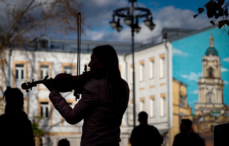 A woman plays the violin for a living in the centre of Moscow, Russia.  EPA