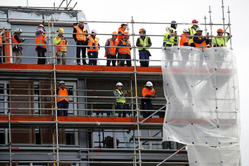 Construction workers wait to see Prince Harry and Meghan at Viaduct Harbour in Auckland. Reuters