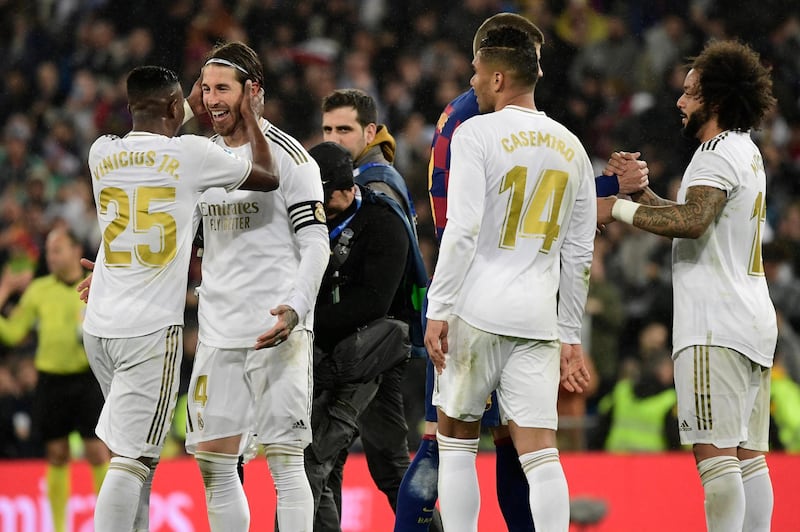 Real Madrid players celebrate their win at the end of the Spanish League football match between Real Madrid and Barcelona at the Santiago Bernabeu stadium in Madrid on March 1, 2020. (Photo by JAVIER SORIANO / AFP)