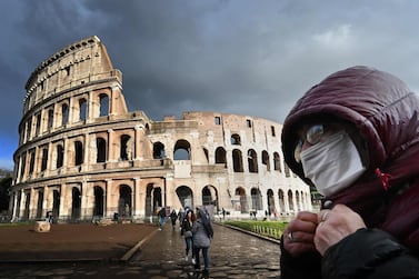 A man wearing a protective mask passes by the Colosseum in Rome on March 7 amid fear of Covid-19 epidemic. AFP 