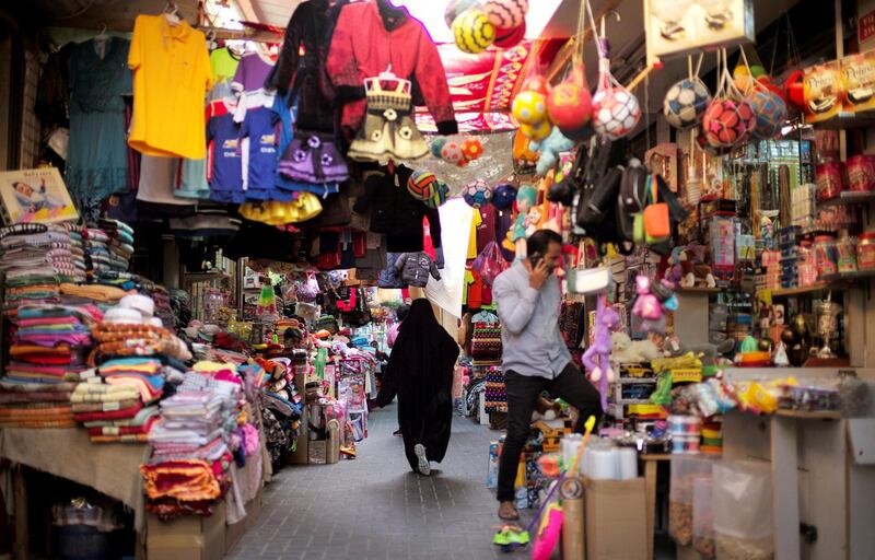 A Bahraini woman walks through local souq as she looks for clothes for her children ahead of Eid al-Adha in Manama, Bahrain, August 19, 2018. REUTERS/Hamad I Mohammed