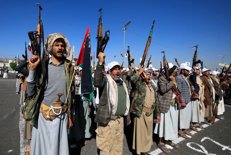 Newly recruited members of the Houthis' popular army brandish firearms at a parade in Sanaa, Yemen. EPA