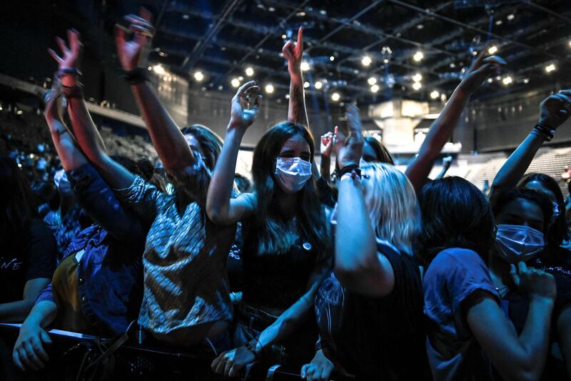 People cheer during a concert of French DJ Etienne de Crecy and pop band Indochine at the AccorHotels Arena in Paris, France. AFP