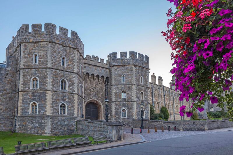 Windsor Castle in the morning with flowers in hanging baskets, Windsor, Berkshire, England, United Kingdom, Europe. Getty Images