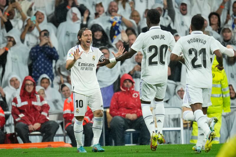 Luka Modric celebrates with Real Madrid teammates after scoring the opening goal. AP