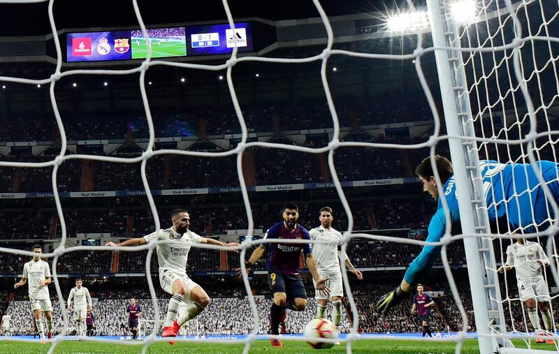 Real Madrid's goalkeeper Thibaut Courtois dives for the ball. AFP