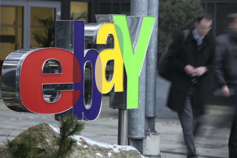 KLEINMACHNOW - DECEMBER 17:  People walk by a sign for Internet auction portal eBay at the eBay Germany headquarters on December 17, 2009 in Kleinmachnow, Germany. The German service industry labour union ver.di has announced that eBay is to fire 400 of the 630 employees at the Kleinmachnow center.  (Photo by Sean Gallup/Getty Images)