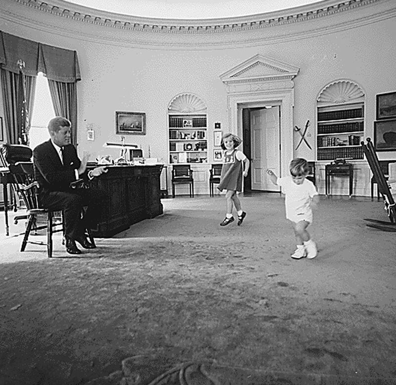 US president John F Kennedy with his children Caroline Kennedy and John F Kennedy Jr in the Oval Office on October 10, 1962. AFP 