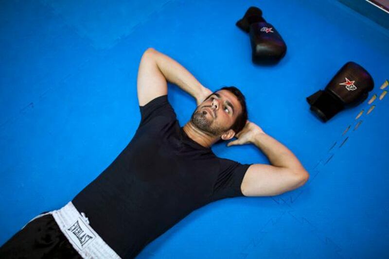 ABU DHABI, UAE - July 6, 2011-  Ahmed Al Hosani warms up at World Gym in Abu Dhabi on Wednesday July 6, 2011.  A rare illness left Ahmed Al Hosani deaf and mute at the age of two.  All he wanted was to be like everyone else.  As a member of the Abu Dhabi Special Needs club, Ahmed has found salvation in kick-boxing, turning professional last month.  Recently he drew his first fight in Dubai and now wants to compete in the Olympics next year.  (Andrew Henderson / The National)