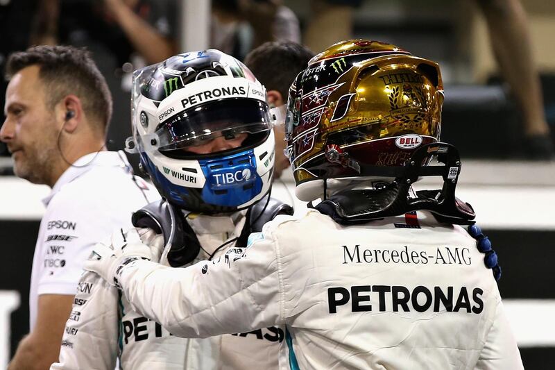 ABU DHABI, UNITED ARAB EMIRATES - NOVEMBER 24: Pole position qualifier Lewis Hamilton of Great Britain and Mercedes GP celebrates with second place qualifier Valtteri Bottas of Finland and Mercedes GP in parc ferme during qualifying for the Abu Dhabi Formula One Grand Prix at Yas Marina Circuit on November 24, 2018 in Abu Dhabi, United Arab Emirates.  (Photo by Charles Coates/Getty Images)