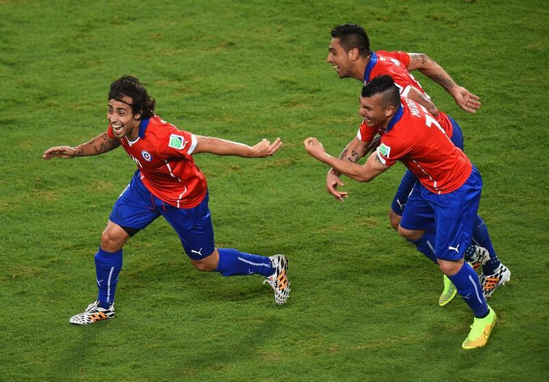 Jorge Valdivia of Chile, left, celebrates scoring the teams second goal with Arturo Vidal, centre, and Gary Medel during the 2014 FIFA World Cup Brazil Group B match between Chile and Australia at Arena Pantanal on June 13, 2014 in Cuiaba, Brazil. Stu Forster/Getty Images