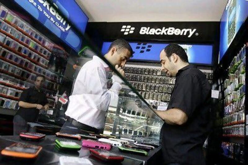 A Lebanese man looks at BlackBerry phones at a BB shop in downtown Beirut on Augut 6, 2010. Lebanon will assess security concerns relating to the use of BlackBerry in the country following the arrest of several telecom employees suspected of spying for Israel, the chairman of the Telecoms Regulatory Authority said. AFP PHOTO/JOSEPH EID *** Local Caption *** 144754-01-08.jpg
