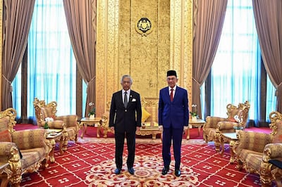 This handout picture taken and released by the National Palace on October 13, 2020 shows Malaysian politician Anwar Ibrahim (R) and Malaysia's King, Sultan Abdullah Sultan Ahmad Shah (L) pose for pictures before their meeting at National Palace in Kuala Lumpur. Malaysian opposition leader Anwar Ibrahim had a long-awaited meeting with the king October 13, seeking to prove he has support to take power and fulfil a decades-old ambition of becoming premier. - -----EDITORS NOTE --- RESTRICTED TO EDITORIAL USE - MANDATORY CREDIT "AFP PHOTO / MALAYSIA NATIONAL PALACE" - NO MARKETING - NO ADVERTISING CAMPAIGNS - DISTRIBUTED AS A SERVICE TO CLIENTS 
 / AFP / Malaysia National Palace / Handout / -----EDITORS NOTE --- RESTRICTED TO EDITORIAL USE - MANDATORY CREDIT "AFP PHOTO / MALAYSIA NATIONAL PALACE" - NO MARKETING - NO ADVERTISING CAMPAIGNS - DISTRIBUTED AS A SERVICE TO CLIENTS 
