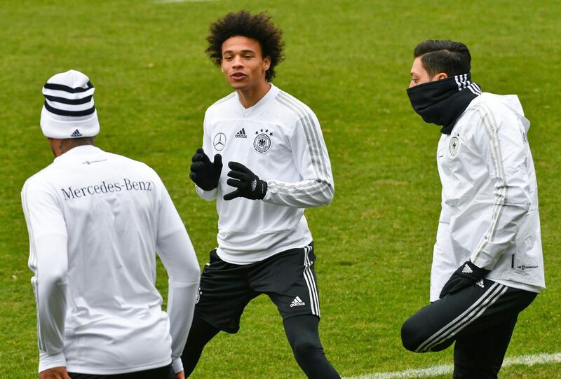 Players of the German national football team (L-R) Jerome Boateng, Leroy Sane and Mesut Ozil joke as they attend a training session ahead of their international friendly match against Spain at Paul-Janes-Stadion on March 21, 2018 in Duesseldorf, western Germany.
The international friendly match in preparataion of the Football World Cup is taking place on March 23, 2018 in Duesseldorf. / AFP PHOTO / Patrik STOLLARZ