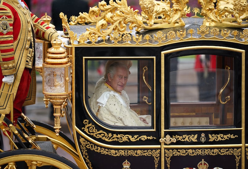 King Charles in the Diamond Jubilee State Coach as the King's Procession passes along The Mall to the coronation ceremony at Westminster Abbey. PA