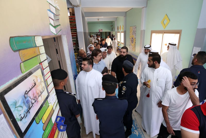 Kuwaitis queue up at a school turned into a polling station to vote during parliamentary elections in Kuwait City on September 29, 2022. Kuwait is holding its most inclusive elections in a decade, with some opposition groups ending a boycott after the country's royal rulers pledged not to interfere with Parliament. AFP