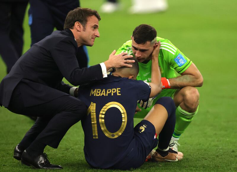 French President Emmanuel Macron comforts Kylian Mbappe after the penalty shoot-out defeat to Argentina. EPA