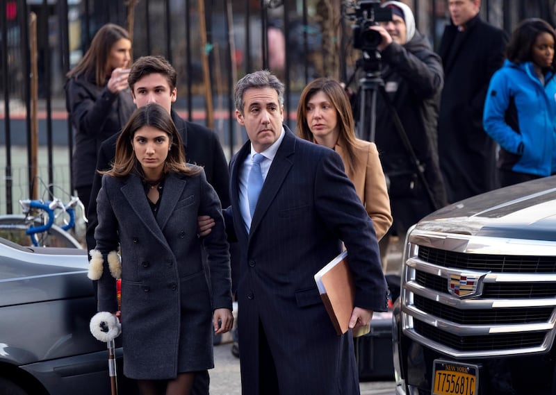 ADDS NAME OF FAMILY MEMBERS - Michael Cohen, second from right, President Donald Trump's former lawyer, accompanied by his children from left, Samantha and Jake, and his wife Laura Shusterman, right, arrives at federal court for his sentencing for dodging taxes, lying to Congress and violating campaign finance laws Wednesday, Dec. 12, 2018, in New York. (AP Photo/Craig Ruttle)
