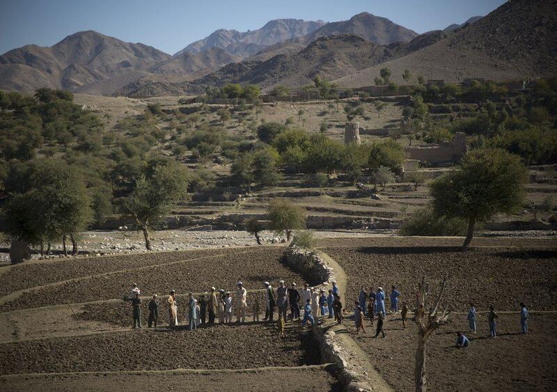 Afghan villagers take a break after preparing the soil for their poppy seeds in fields in Cham Kalai village in Afghanistan’s eastern Nangarhar province, an area which is largely controlled by Taliban. Anja Niedringhaus / AP Photo