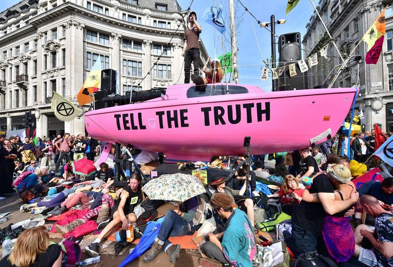 LONDON, ENGLAND - APRIL 18: Climate protesters gather around a boat at Oxford Circus during the fourth day of a coordinated protest by the Extinction Rebellion group on April 18, 2019 in London, England. More than 100 arrests have been made, with demonstrations blocking a number of locations across the capital. (Photo by Leon Neal/Getty Images)