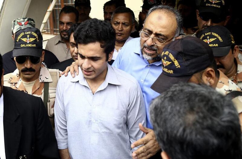 Sajjad Ali Shah  with his now-released son Owais.  Rehan Khan / EPA