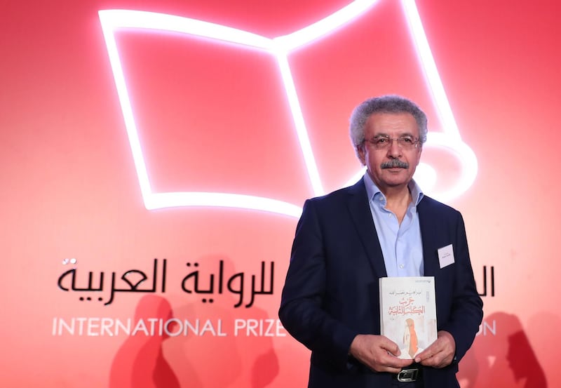 Palestinian writer Ibrahim Nasrallah poses for a photo after winning the 2018 International Prize for Arabic Fiction for his book titled "The Second war of the Dog" in Abu Dhabi on April 24, 2018. / AFP PHOTO / KARIM SAHIB