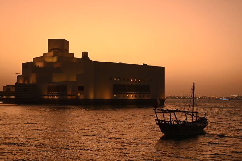4. A Dhow is seen at Doha Bay next to the Museum of Islamic Art at sunset. Getty Images