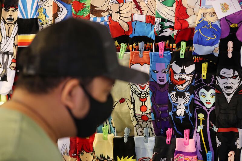 A visitor looks at different characters featured on socks. Visitors can pick up specialised products from High Score Con