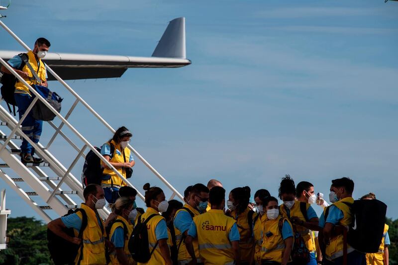 Volunteer doctors from Spain, Portugal, Argentina and Costa Rica, arrive at the Oscar Arnulfo Romero International Airport in Comalapa, El Salvador. AFP