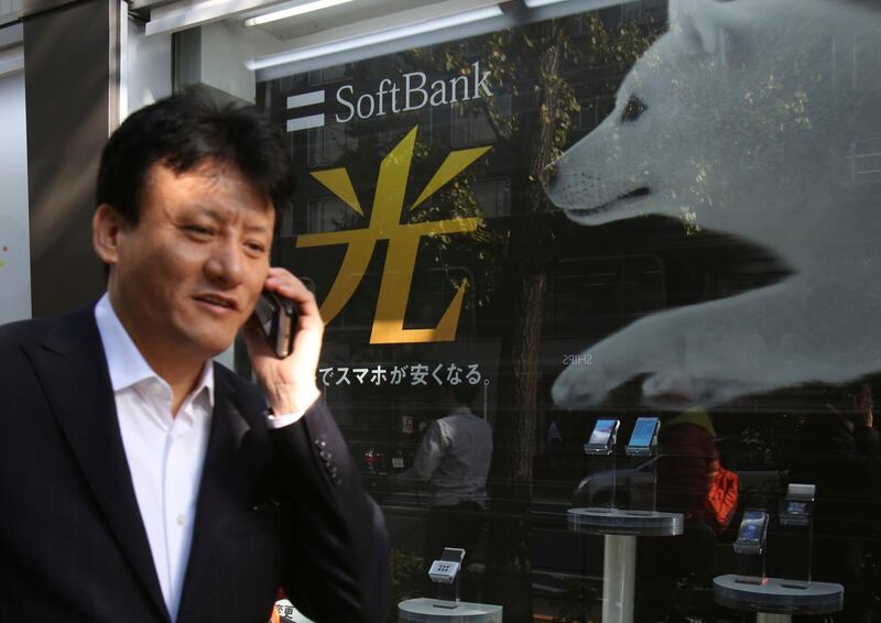 In this Nov. 10, 2017, photo, a man walks past an advertisement of SoftBank, in Tokyo.  Japanese technology company Softbank said Monday, Aug 6, 2018, its profits grew to 313.7 billion yen ($2.8 billion) in the latest quarter as it realized gains from sales by its Softbank Vision investment fund. (AP Photo/Koji Sasahara)