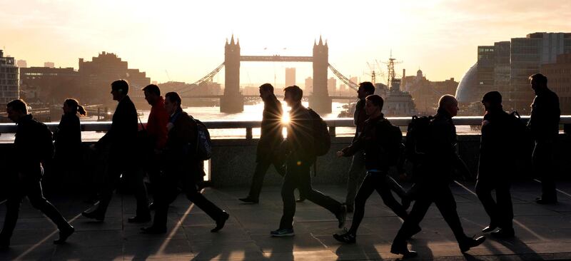 (FILES) In this file photo taken on March 02, 2017 Morning commuters walk across London Bridge with Tower Bridge in the background into the City of London on March 2, 2017. 
The image of the British financial sector is of a world of overpaid men, a symbol of glaring wage inequalities and women's difficulties in gaining access to the highest positions. New regulations have forced the big names in British finance to publish wage differentials between men and women and the numbers are not flattering. / AFP PHOTO / Daniel SORABJI