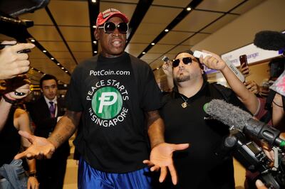 Former NBA basketball player Dennis Rodman, and Chris Volo, right, arrive at Singapore's Changi Airport on Tuesday, June 12, 2018. (AP Photo/Wong Maye-E)