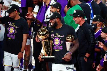 Oct 11, 2020; Lake Buena Vista, Florida, USA; Los Angeles Lakers forward LeBron James (23) smiles while holding the MVP and Finals trophies after game six of the 2020 NBA Finals at AdventHealth Arena. The Los Angeles Lakers won 106-93 to win the series. Mandatory Credit: Kim Klement-USA TODAY Sports
