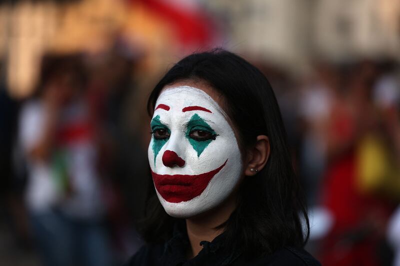 A Lebanese protester, her face painted as DC comic book and film character 'The Joker', in Beirut's downtown district's Martyr's Square, on October 19, 2019. Two years after a now-defunct protest movement shook Lebanon, opposition activists are hoping parliamentary polls will challenge the ruling elite's stranglehold on the country. AFP