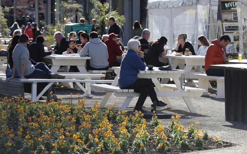 Customers enjoy lunch in the sunshine at the Riverside Market in Christchurch, New Zealand. AP Photo