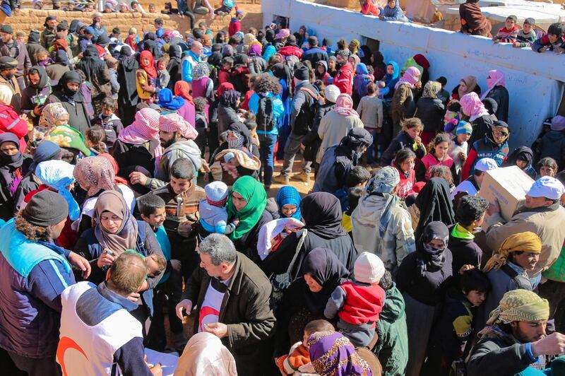 Syrian Arab Red Crescent staffers vaccinate children and women at al-Roukban camp on the Syrian-Jordanian border. EPA