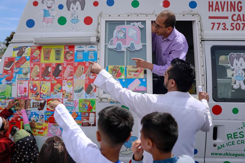 American Muslims buy ice creams after performing Eid Al Fitr prayers on the Niles West High School football field in Skokie, Illinois.