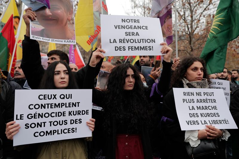 Kurdish activists protest in Paris on Saturday over the shooting at a community cultural centre. AP