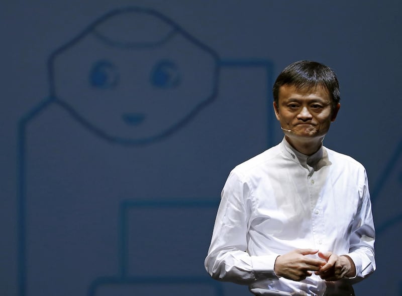 FILE PHOTO - Jack Ma, founder and executive chairman of China's Alibaba Group, speaks in front of a picture of SoftBank's human-like robot named 'pepper' during a news conference in Chiba, Japan, June 18, 2015. REUTERS/Yuya Shino/File Picture