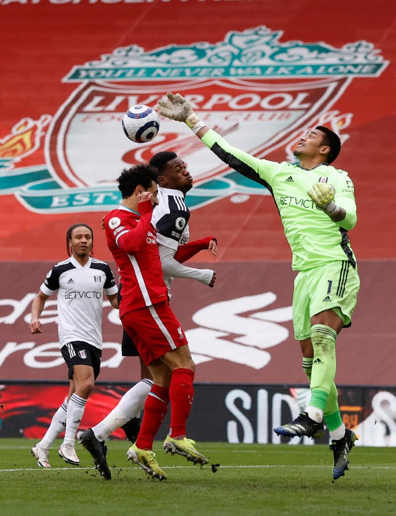 Fulham goalkeeper Alphonse Areola punches clear under pressure from Liverpool's Mohamed Salah. AP